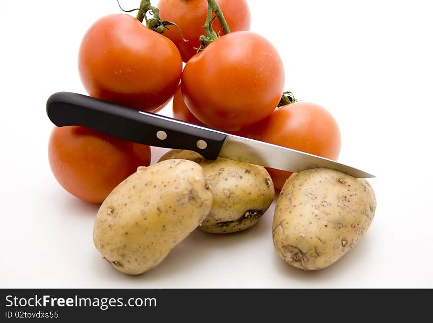 Tomatoes and potatoes with knife