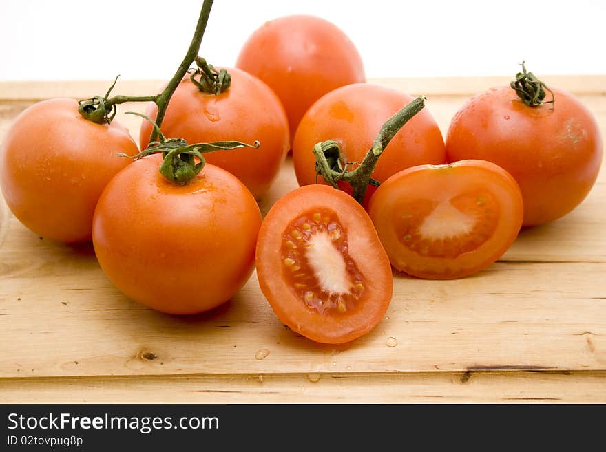 Tomatoes cut onto edge board with knife