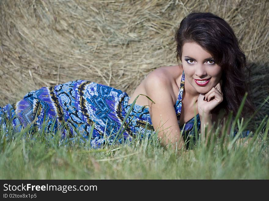 Beautiful girl near haystacks