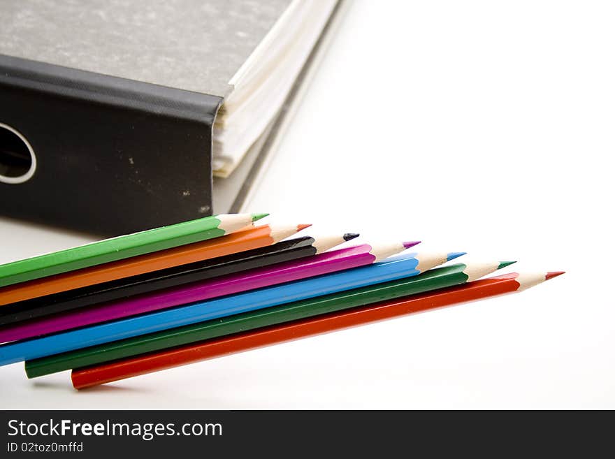 Colored pencils with file of cardboard