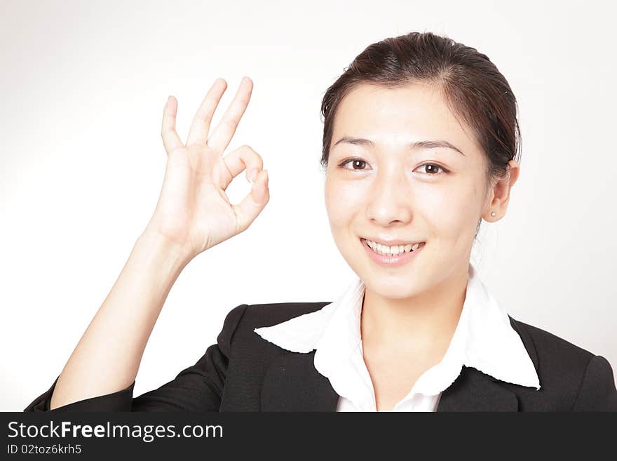 A smiling business woman with an OK gesture. A smiling business woman with an OK gesture