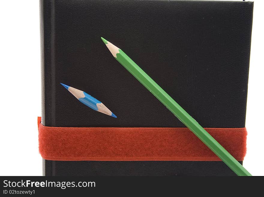 Colored pencils with book