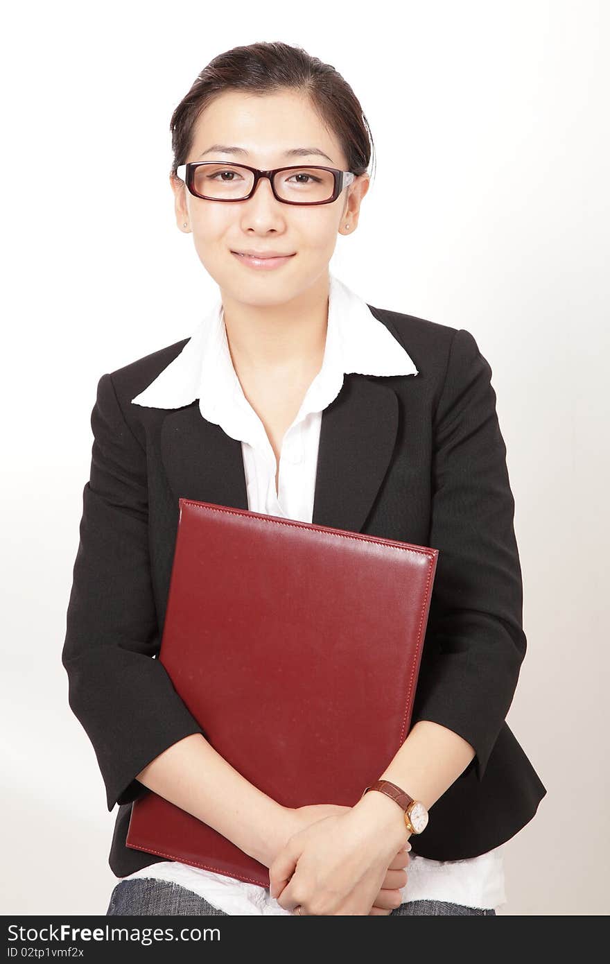 A smiling business woman holding a file. A smiling business woman holding a file.