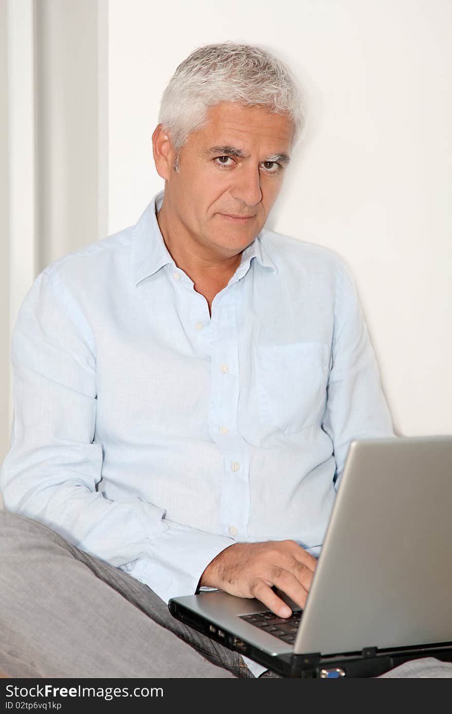 Man sitting on the floor with laptop computer. Man sitting on the floor with laptop computer