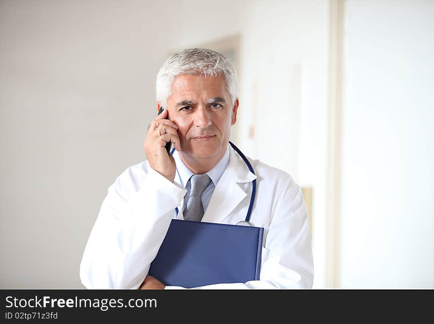 Portrait of doctor standing in hall. Portrait of doctor standing in hall