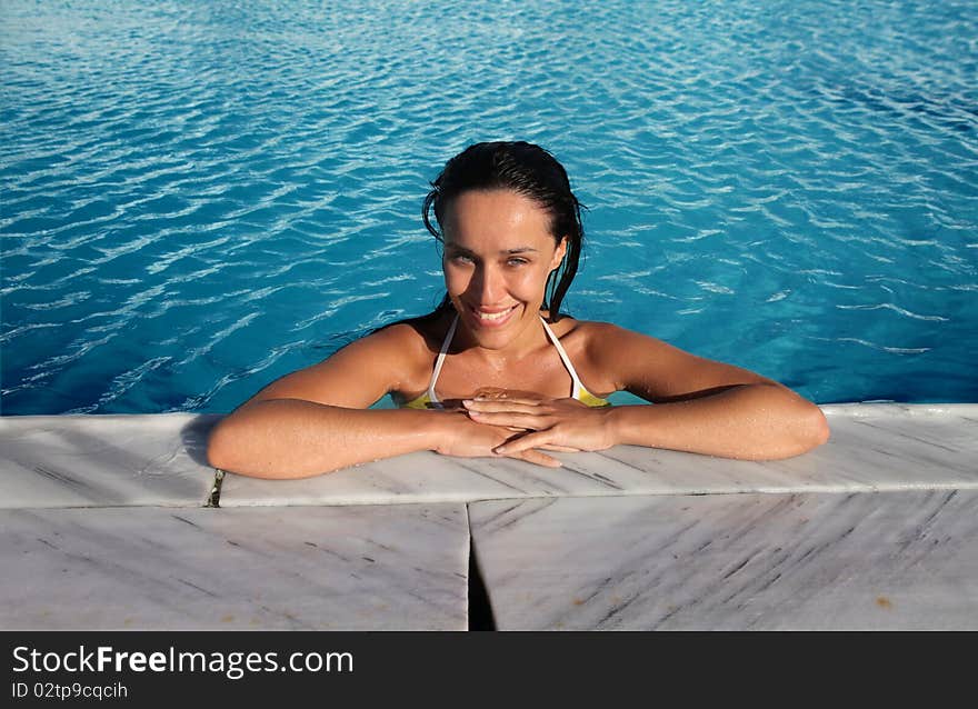 Smiling beautiful woman in a swimming pool. Smiling beautiful woman in a swimming pool