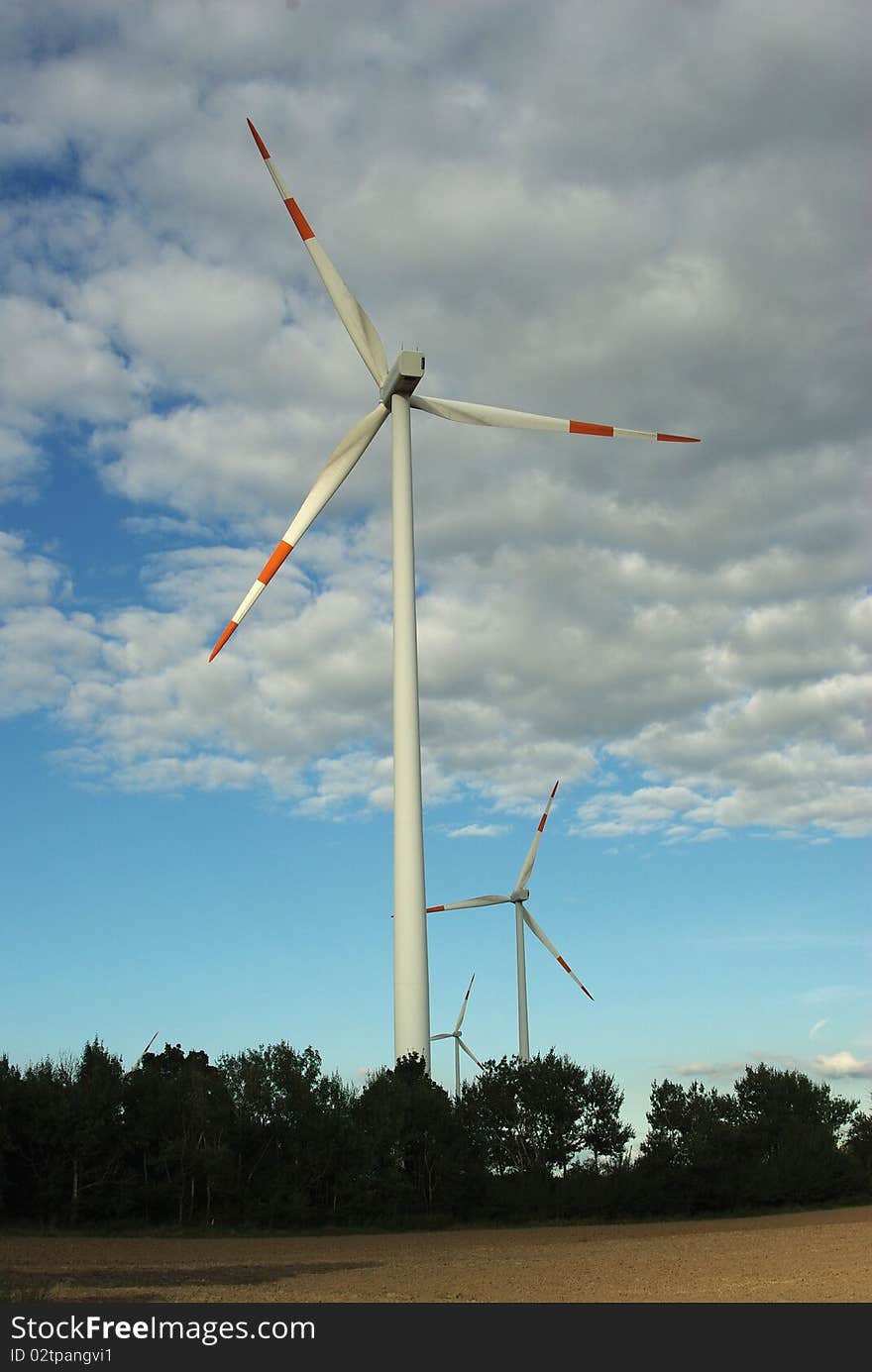 Wind turbine on clouds background