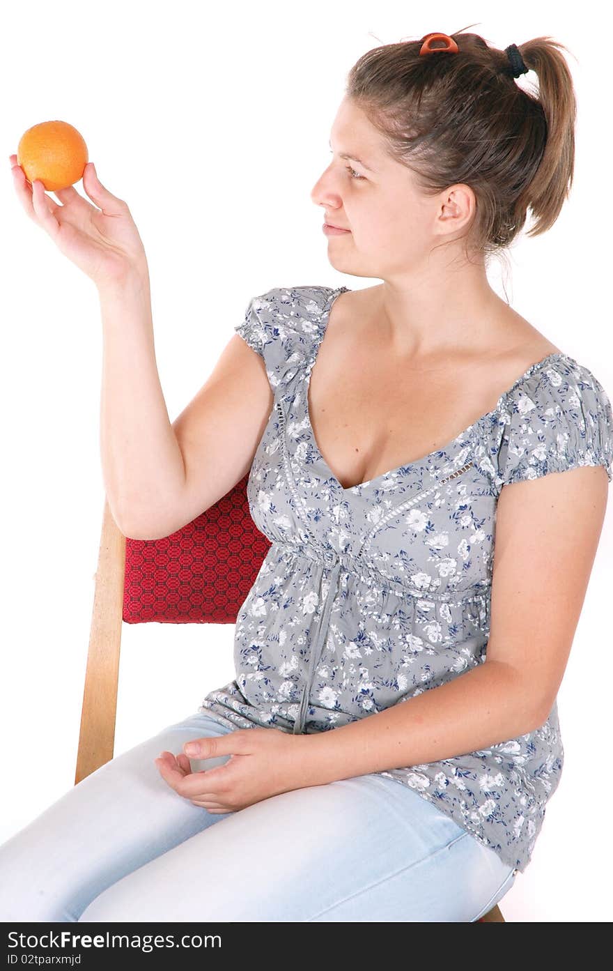 Young girl holding orange fruit isolated on white background. Young girl holding orange fruit isolated on white background