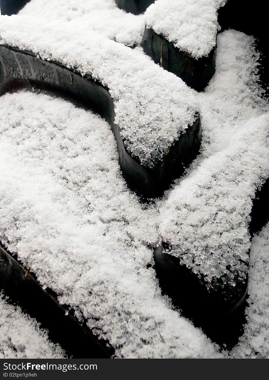 Tractor tires are covered with snow