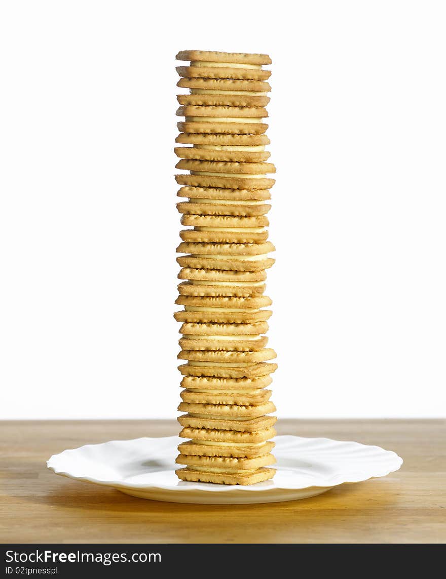 Pile of custard cream biscuits on plate. Pile of custard cream biscuits on plate