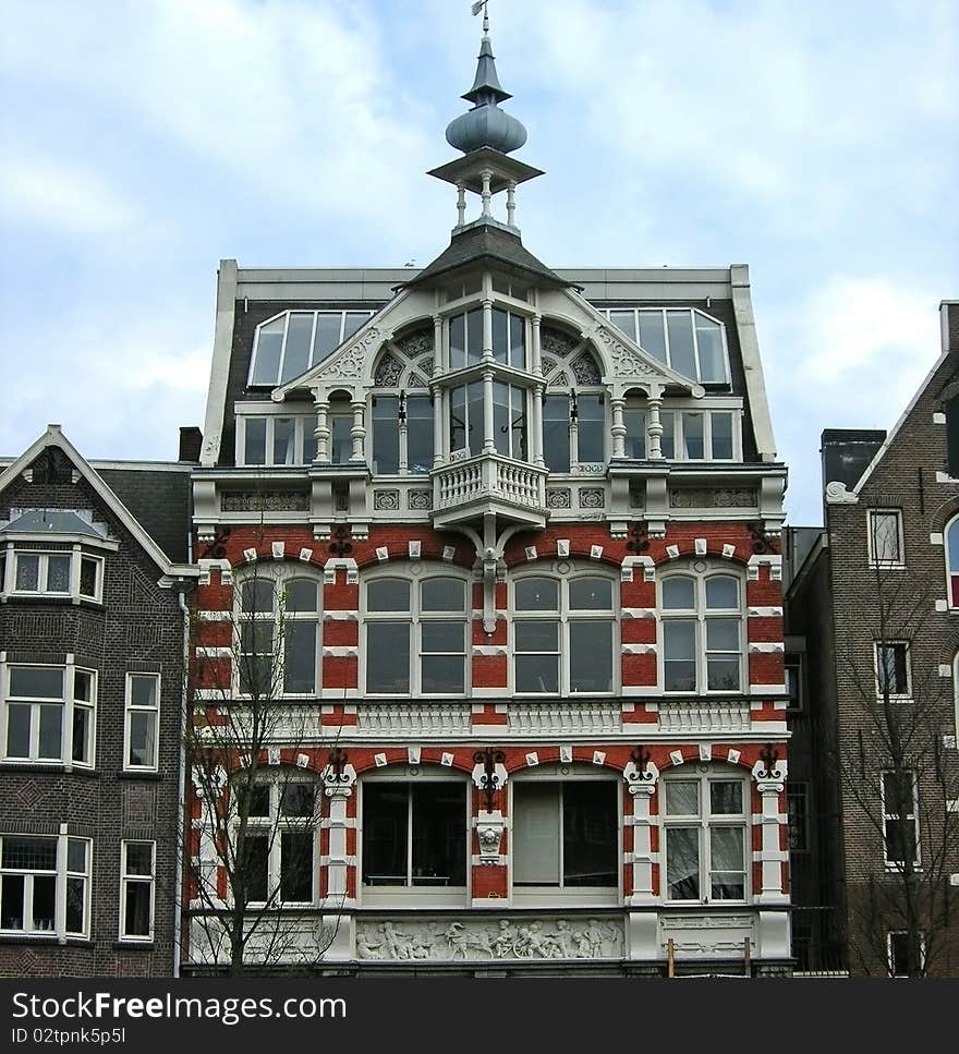 These are very nice historical Amsterdam building. Handsome and interesting architecture. View from the boat. Tourism, Europe, Amsterdam, buildings, boats. These are very nice historical Amsterdam building. Handsome and interesting architecture. View from the boat. Tourism, Europe, Amsterdam, buildings, boats