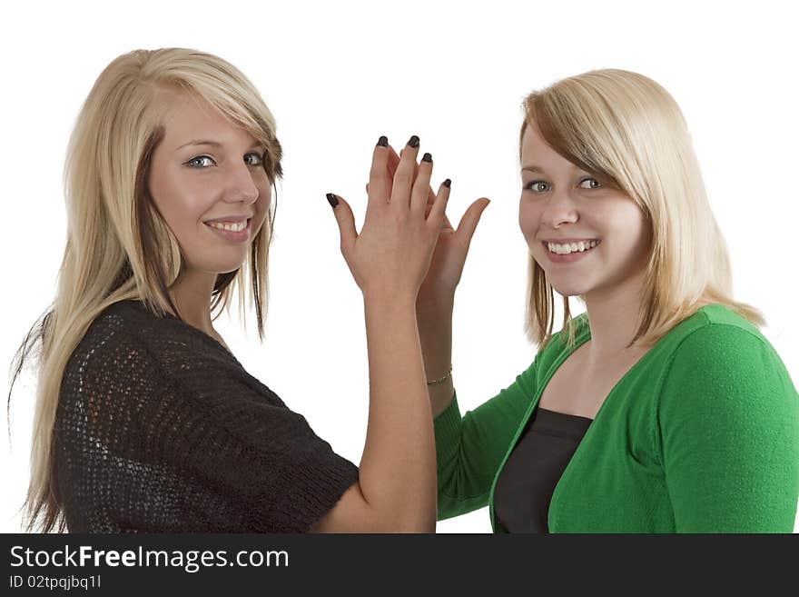 Two young caucasian girlfriends having fun together  isolated over white background. Two young caucasian girlfriends having fun together  isolated over white background