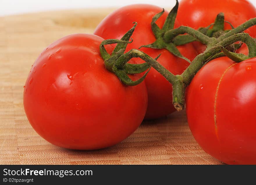 A close-up of fresh tomatos and their leaves