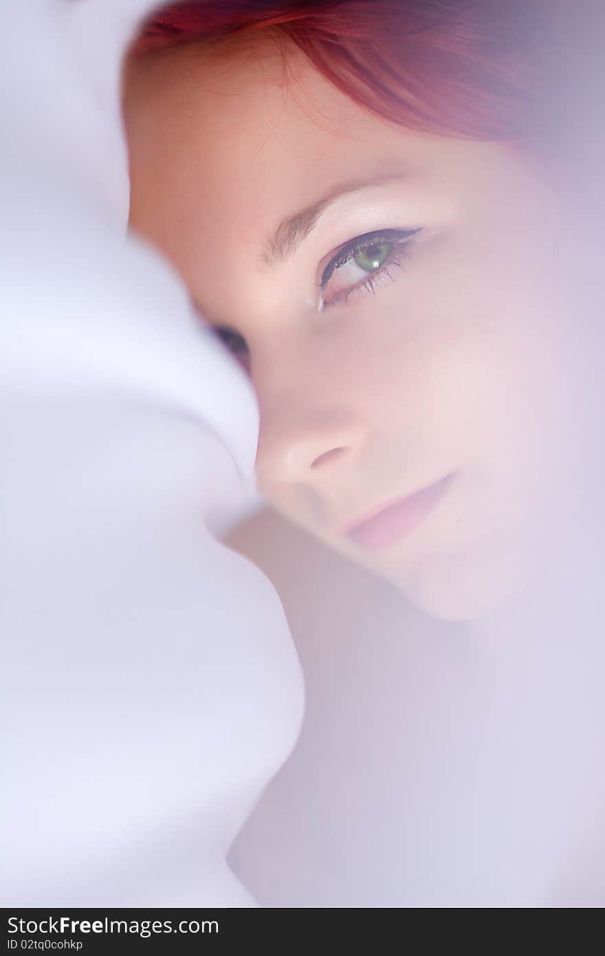 Girl with red hair and white fabrics. Girl with red hair and white fabrics