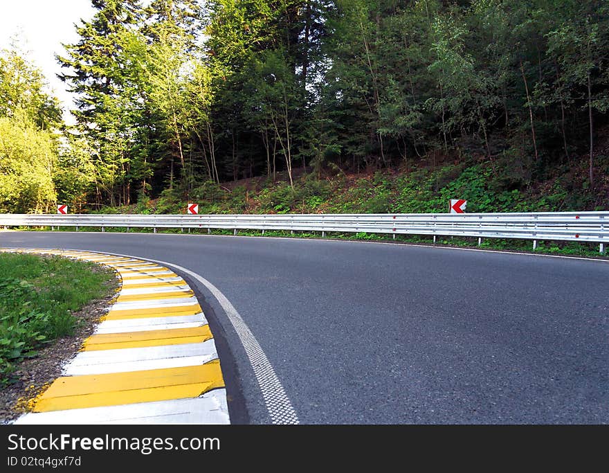 Curved road in the mountain forest