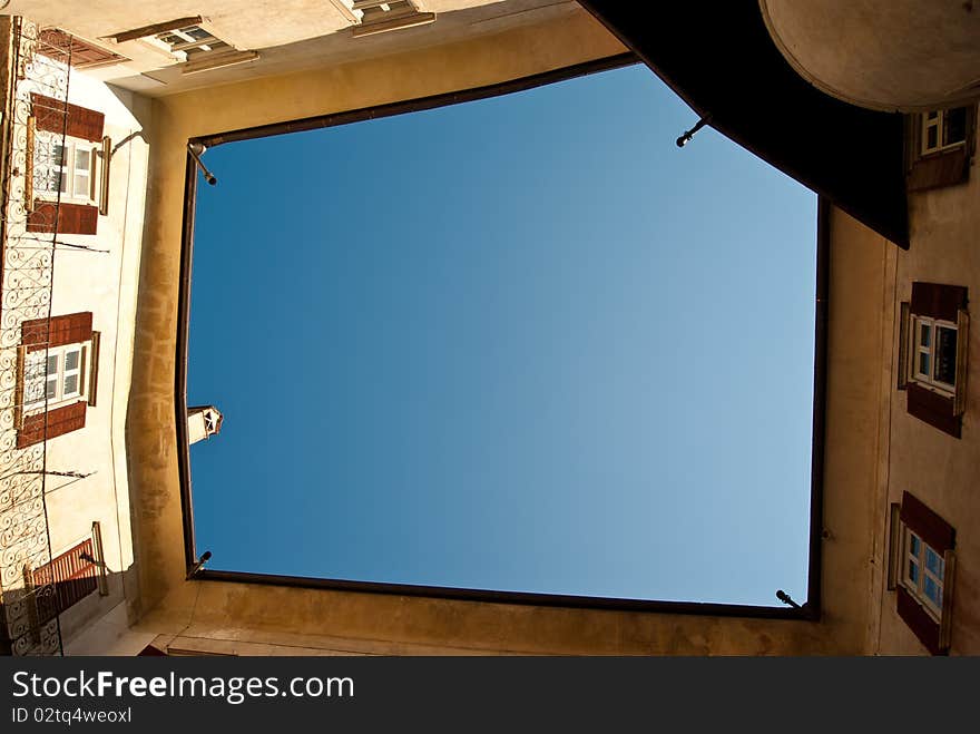 Opening the courtyard of a medieval castle where we see a blue sky and lots of colors in a summer day of August. Opening the courtyard of a medieval castle where we see a blue sky and lots of colors in a summer day of August