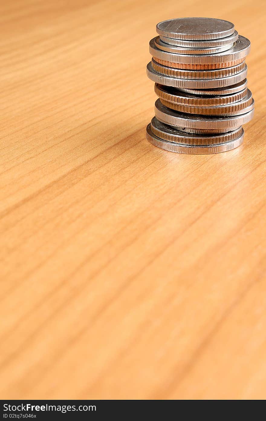 Column Of Coins On Wooden Table