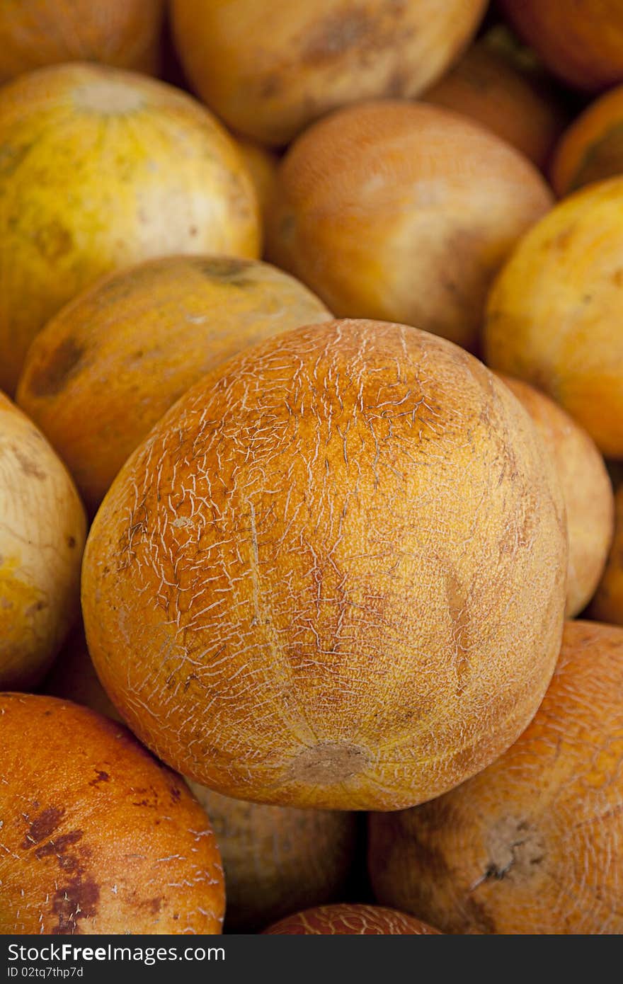 A large group of ripe Israel orange melons in the vertical format. A large group of ripe Israel orange melons in the vertical format.