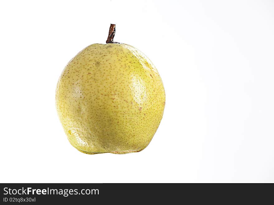 A sweet ripe juicy pear fruit isolated against a white background. A sweet ripe juicy pear fruit isolated against a white background