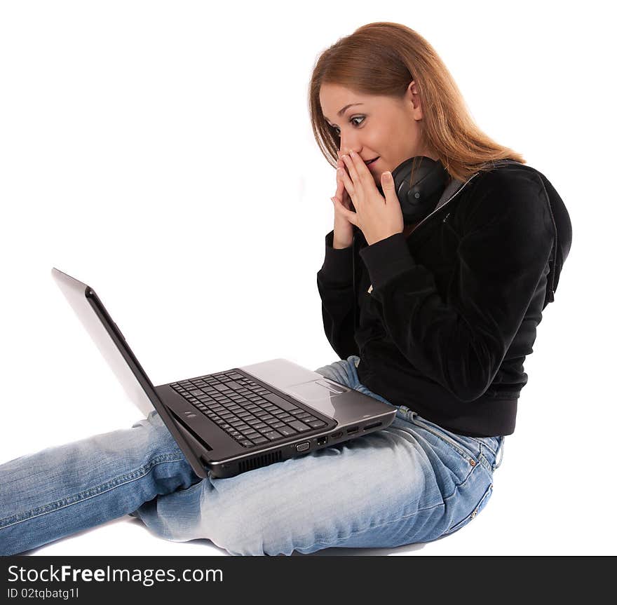 Surprised young woman  with headphones and laptop