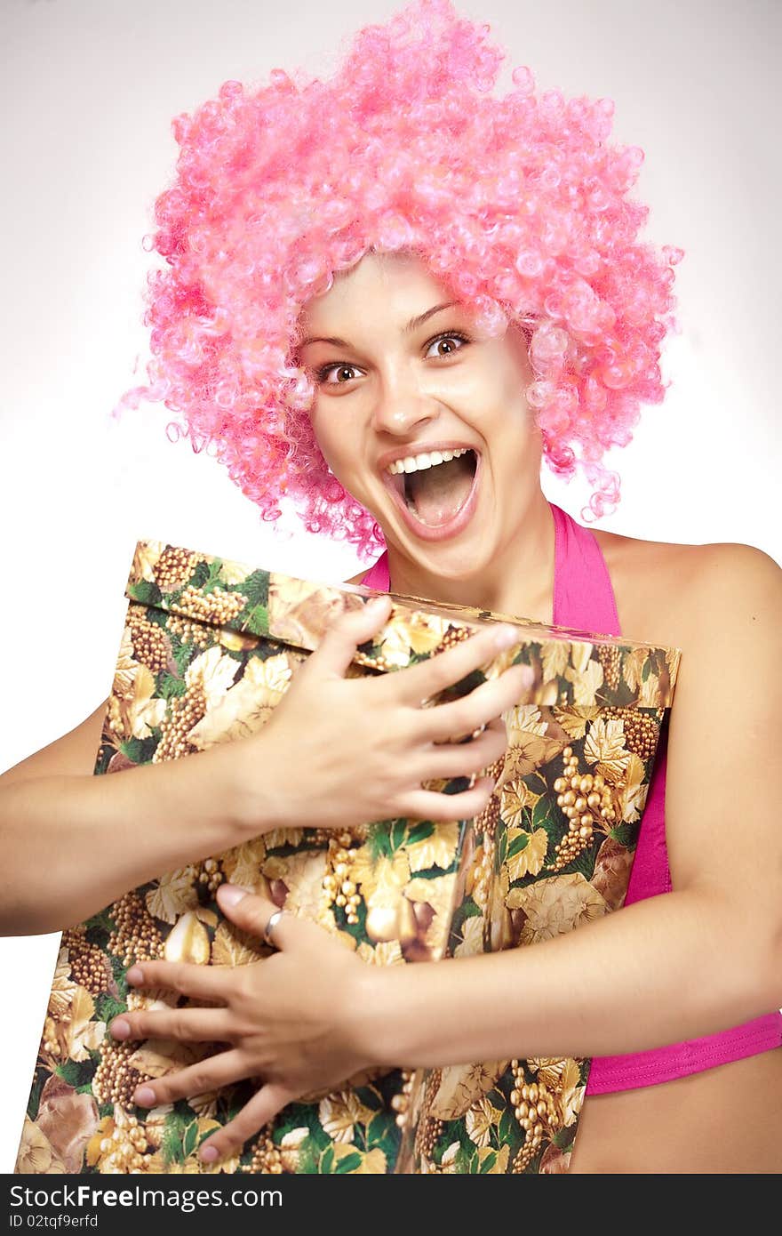 Studio portrait of attractive young woman with a present box