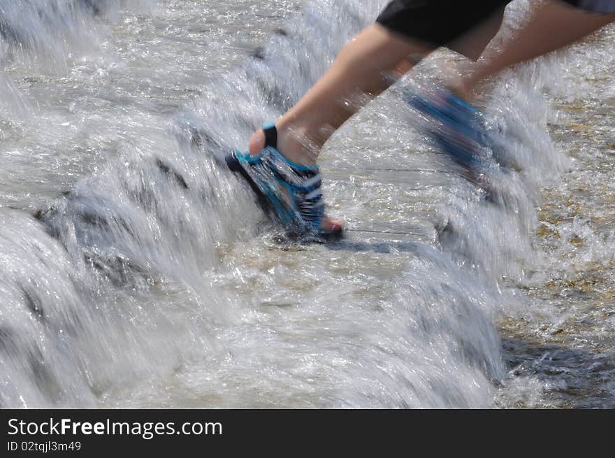 The boy runs on steps. Water flows down on steps. The boy runs on steps. Water flows down on steps.