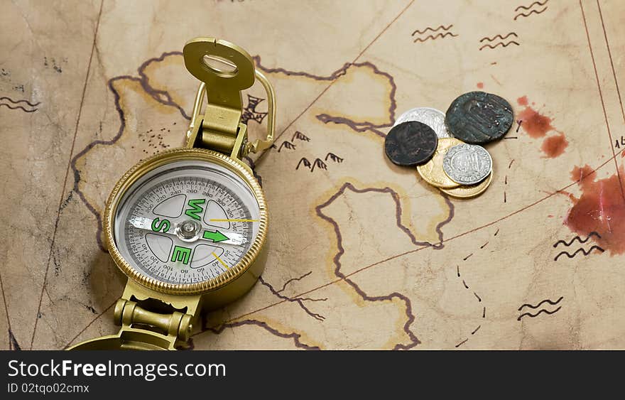 Compass and coins on a map