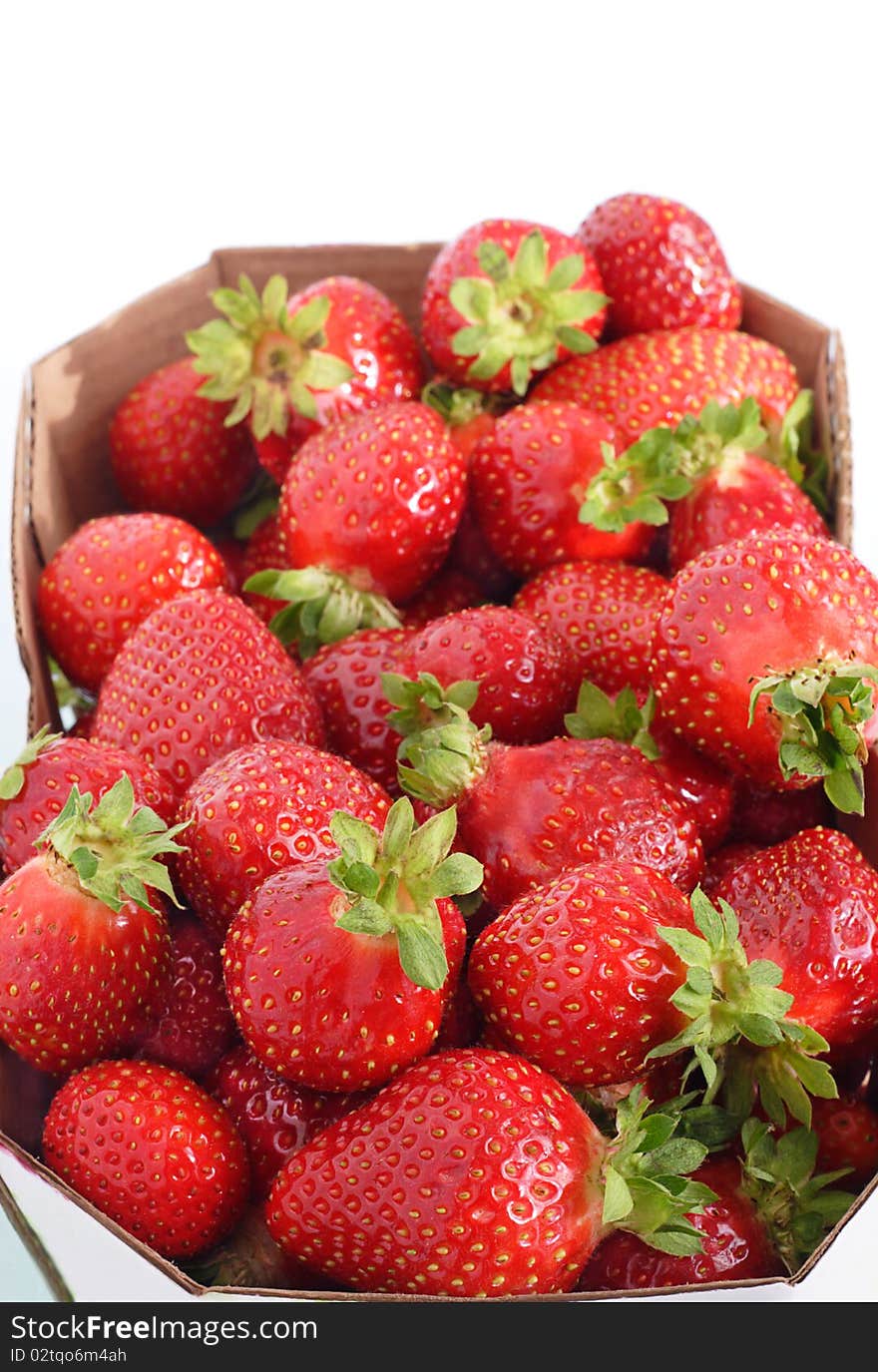 Fresh-picked field grown strawberries on white background