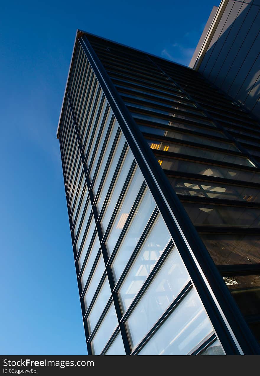 Office building. Blue sky in the background. Glass windows