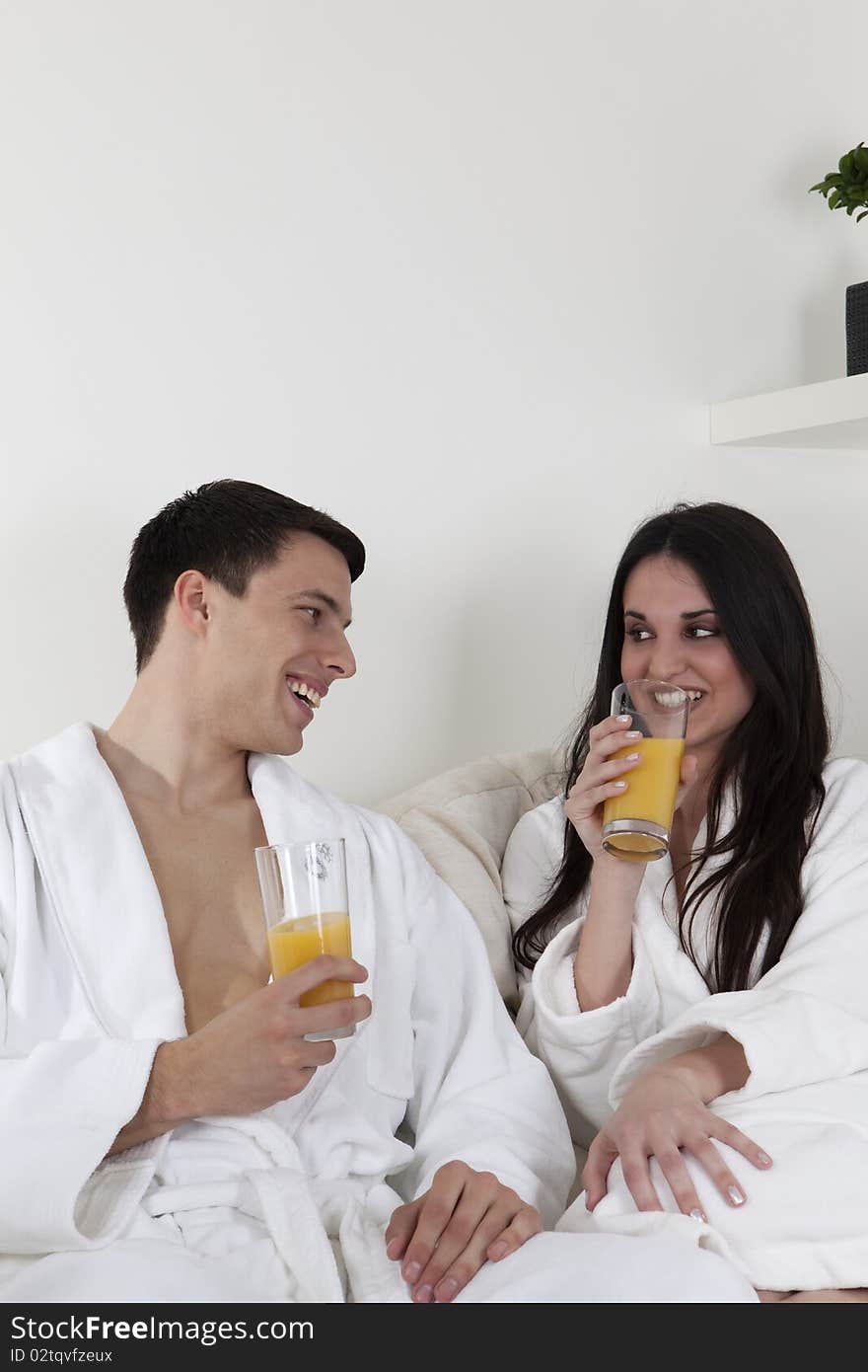 Sexy young smiling couple is having morning together in the appartment, having healthy breakfast. Sexy young smiling couple is having morning together in the appartment, having healthy breakfast