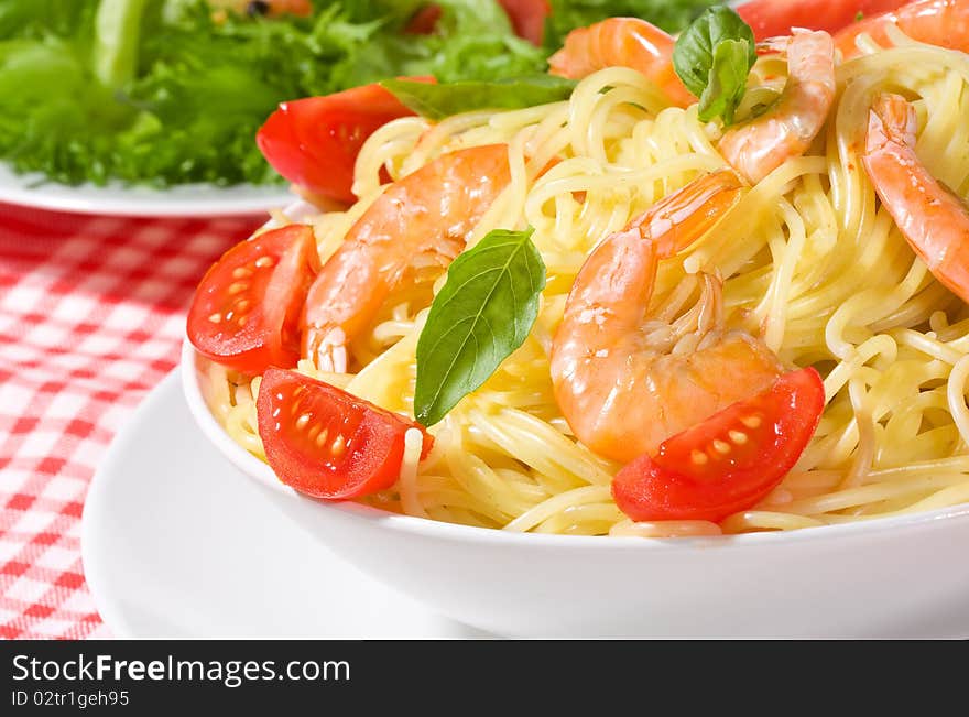 Pasta with shrimps and tomato as background