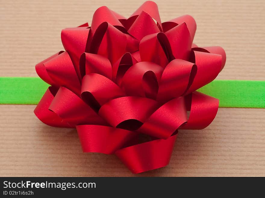 Closeup shot of a Red Bow on Package with Green Ribbon. Closeup shot of a Red Bow on Package with Green Ribbon