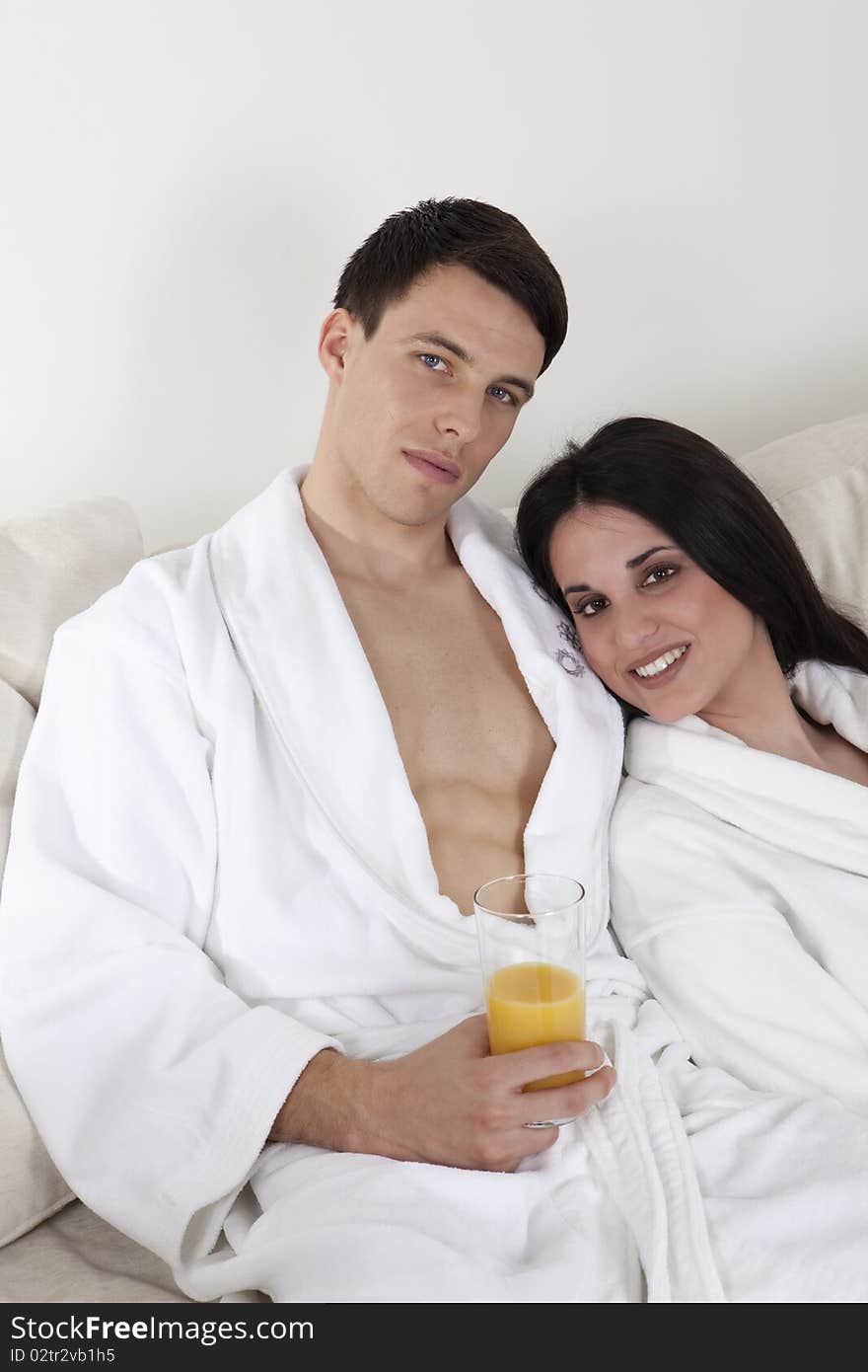 young smiling couple is having morning together in the appartment, having healthy breakfast. young smiling couple is having morning together in the appartment, having healthy breakfast