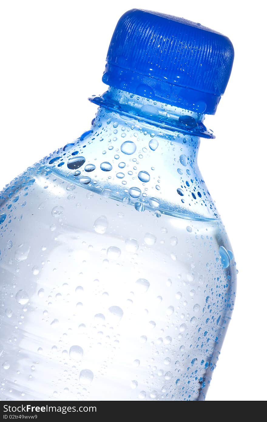 Plastic bottle with water drops on white background