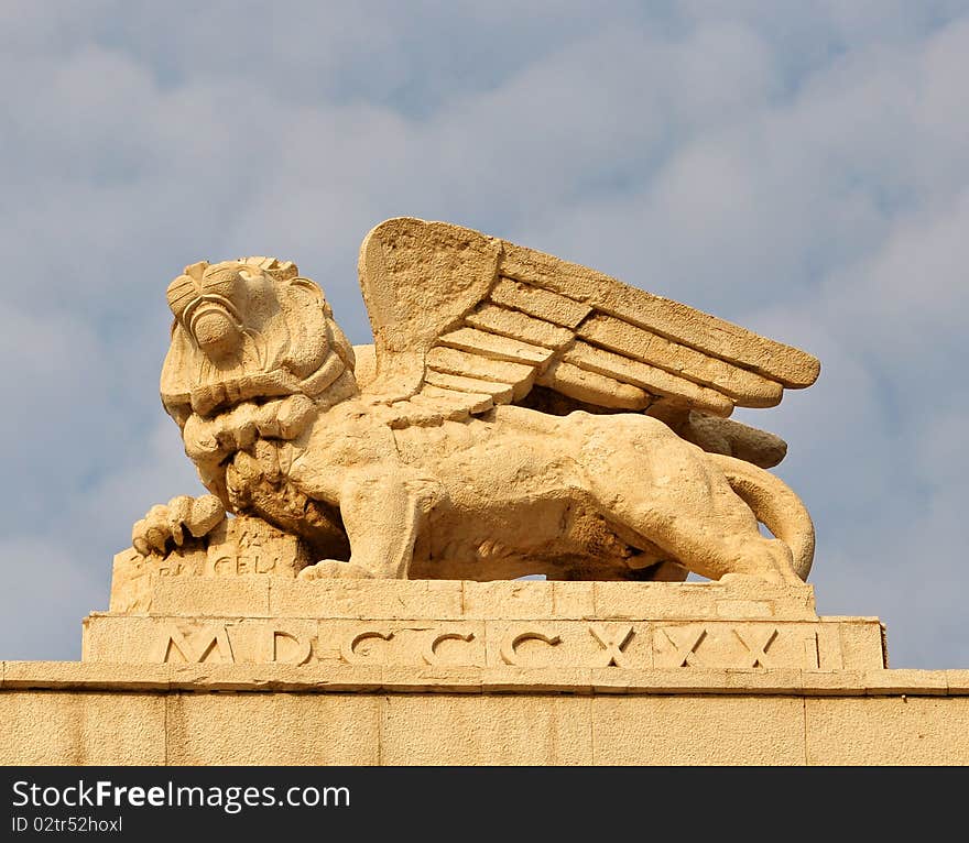 A winged lion statue carved in rock. A winged lion statue carved in rock