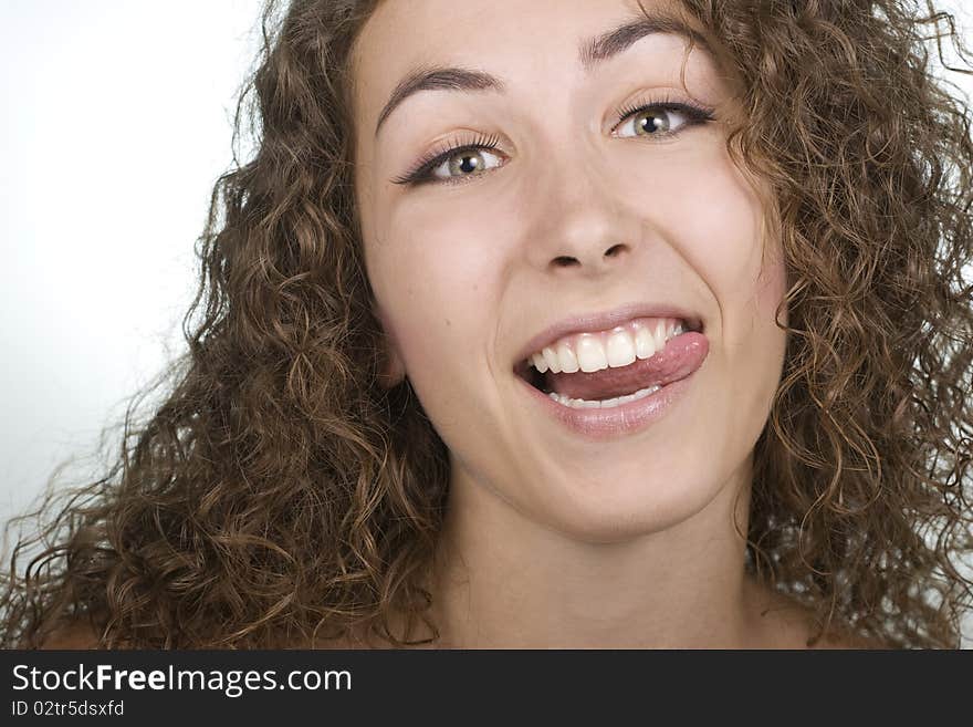 Playful beautiful young woman sticking her tongue out