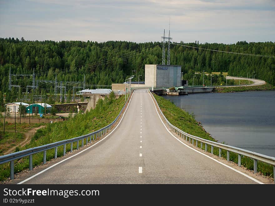 Vanttauskoski hydroelectric plant in northen Finland close to Arctic Circle, seen from the road, there is a border of Kemijoki rivera right and power plant at left. Vanttauskoski hydroelectric plant in northen Finland close to Arctic Circle, seen from the road, there is a border of Kemijoki rivera right and power plant at left