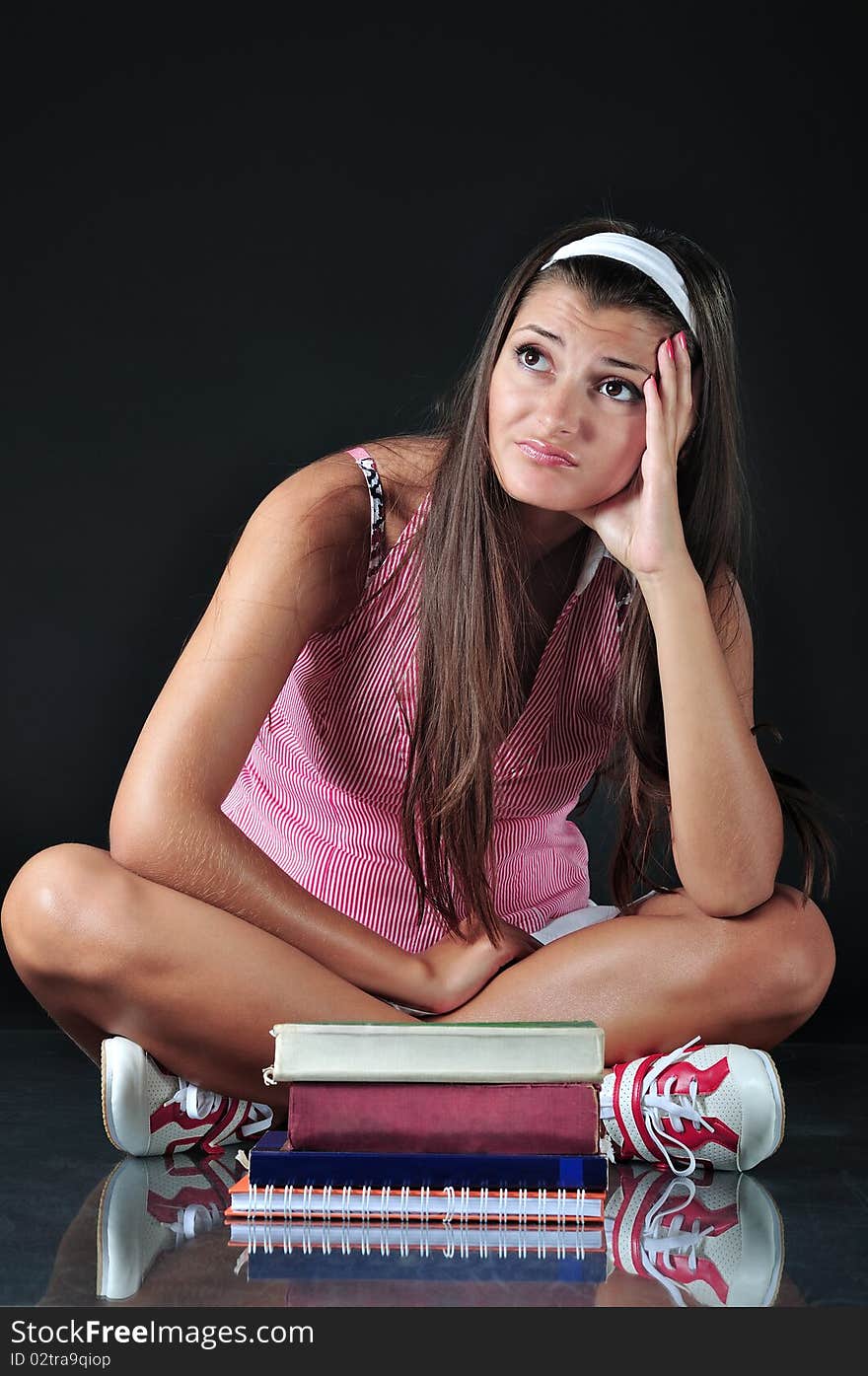 Schoolgirl sitting in front of her books