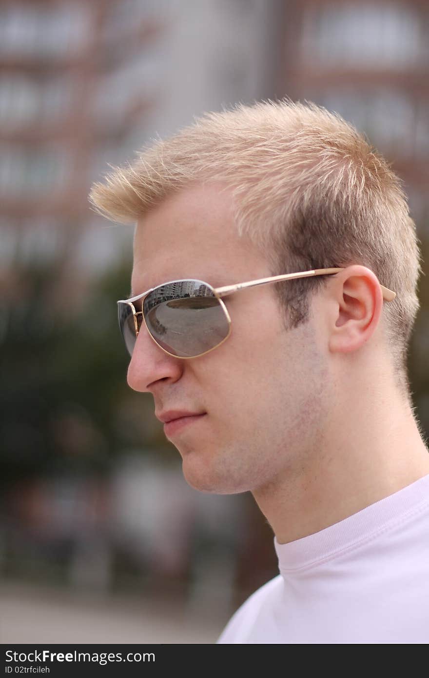 Portrait of the young blonde man in sunglasses