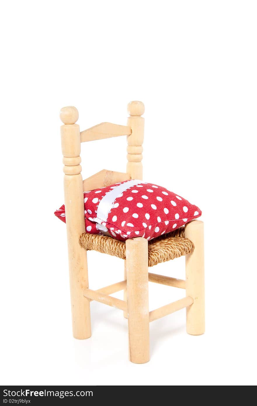 Wooden chair with a dotted pillow