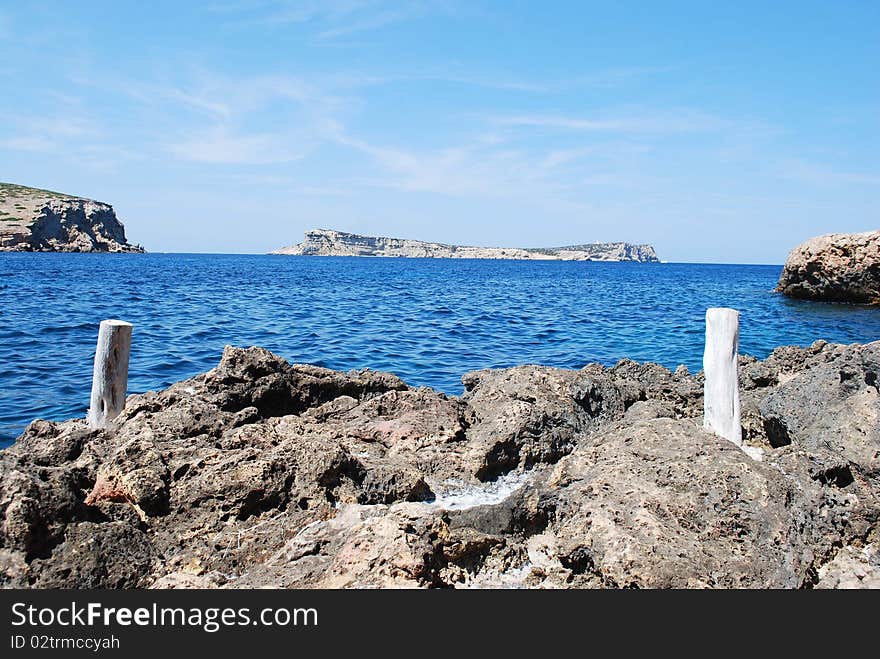 On the horizon, the island of Sa Conillera, near the island of Ibiza. Part of a nature reserve. On the horizon, the island of Sa Conillera, near the island of Ibiza. Part of a nature reserve.