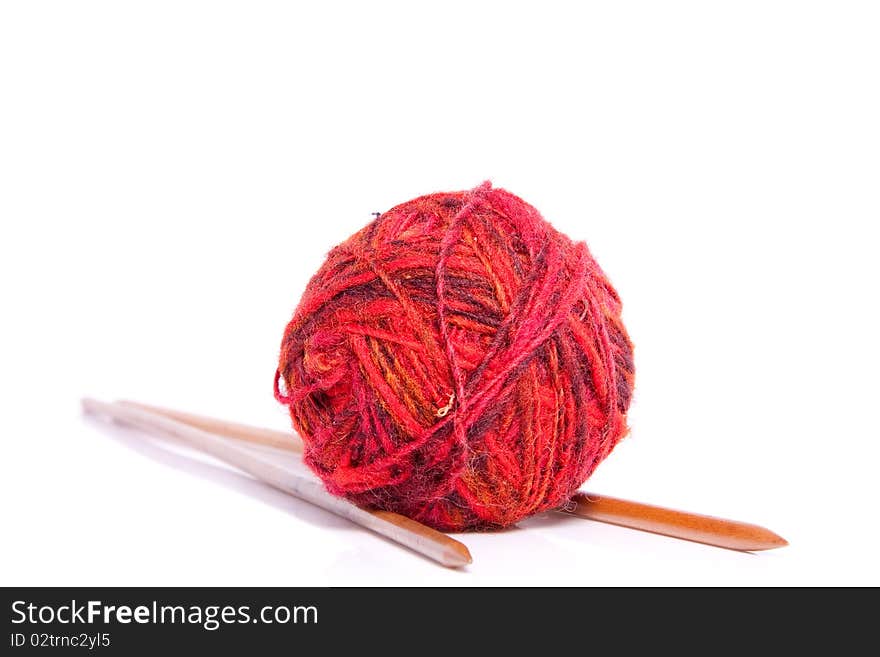 Knitting needles and red wool