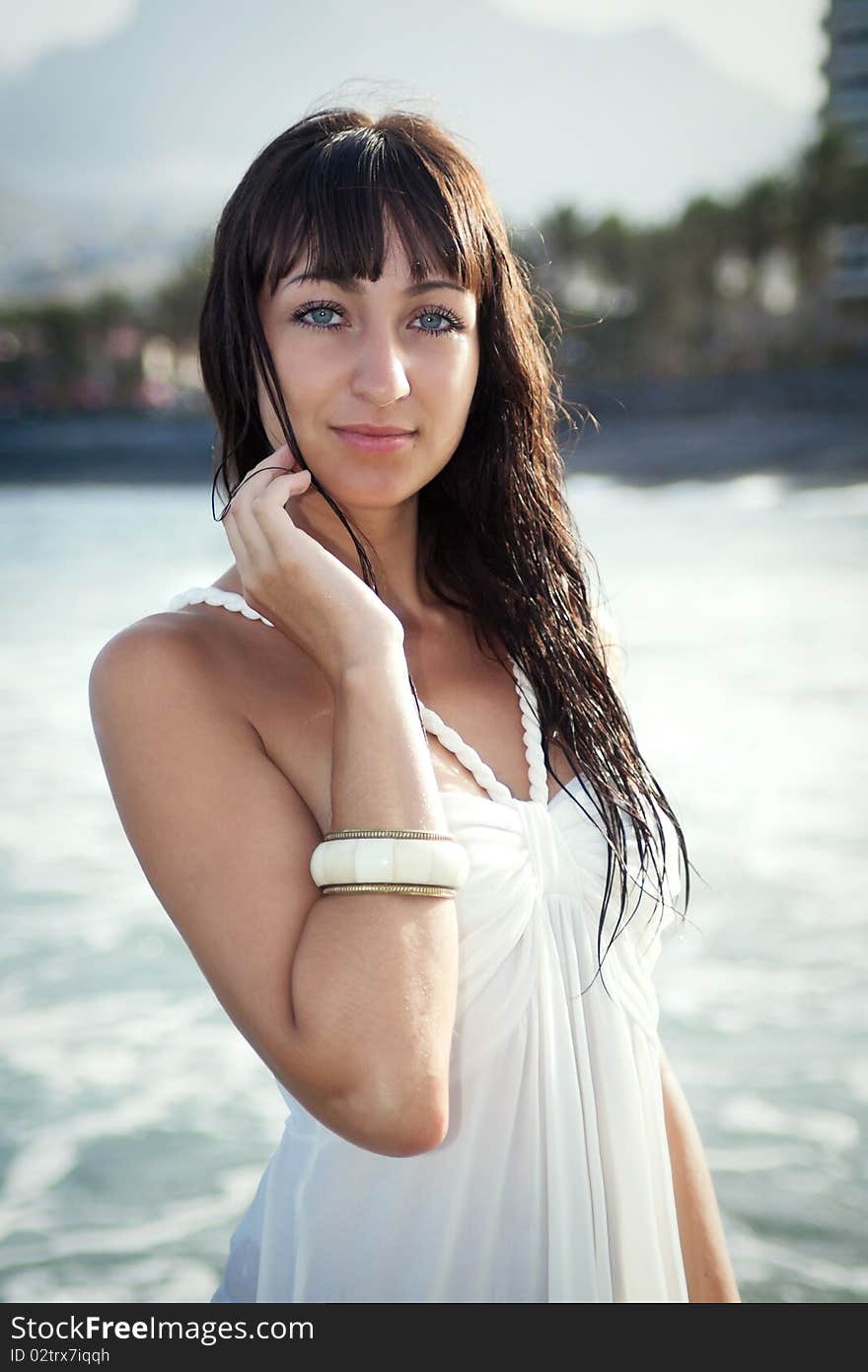 Attractive brunette model standing in water in wet white dress. Southern Tenerife, Canary Islands. Attractive brunette model standing in water in wet white dress. Southern Tenerife, Canary Islands.