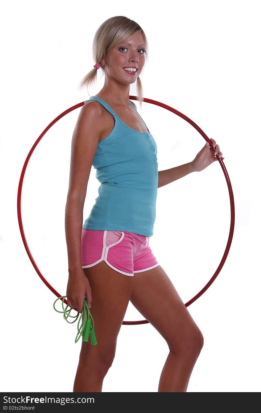 Young woman with the hula hoop and skipping rope isolated on a white. Young woman with the hula hoop and skipping rope isolated on a white.