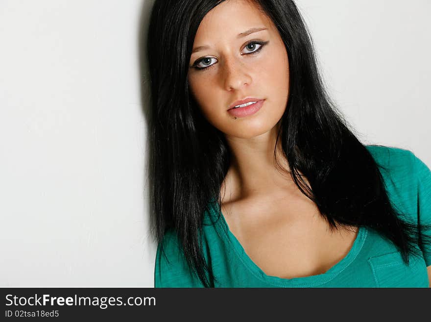 Young woman poses wearing a green shirt. Young woman poses wearing a green shirt.