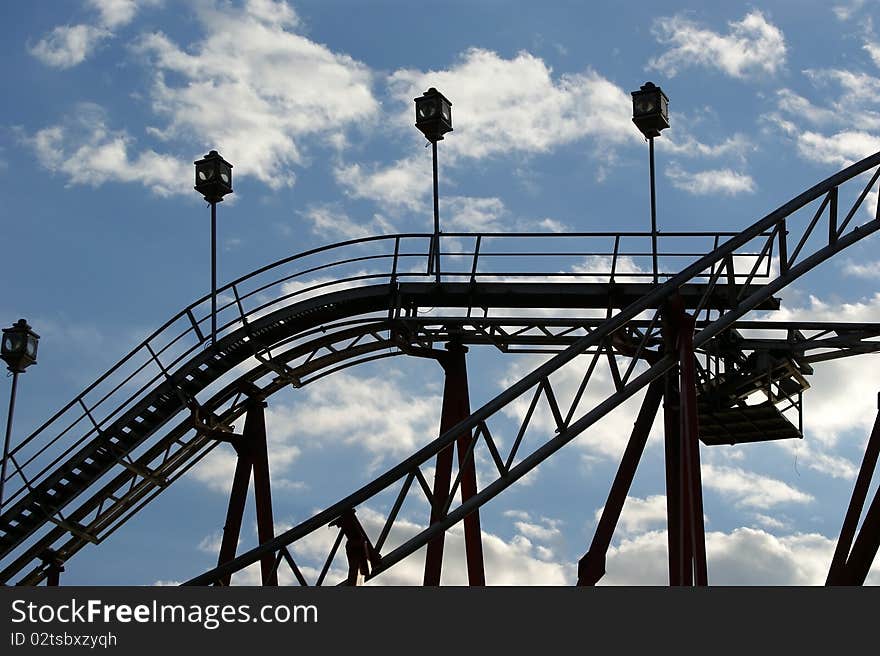 Fragment of the attraction roller coaster close against the sky