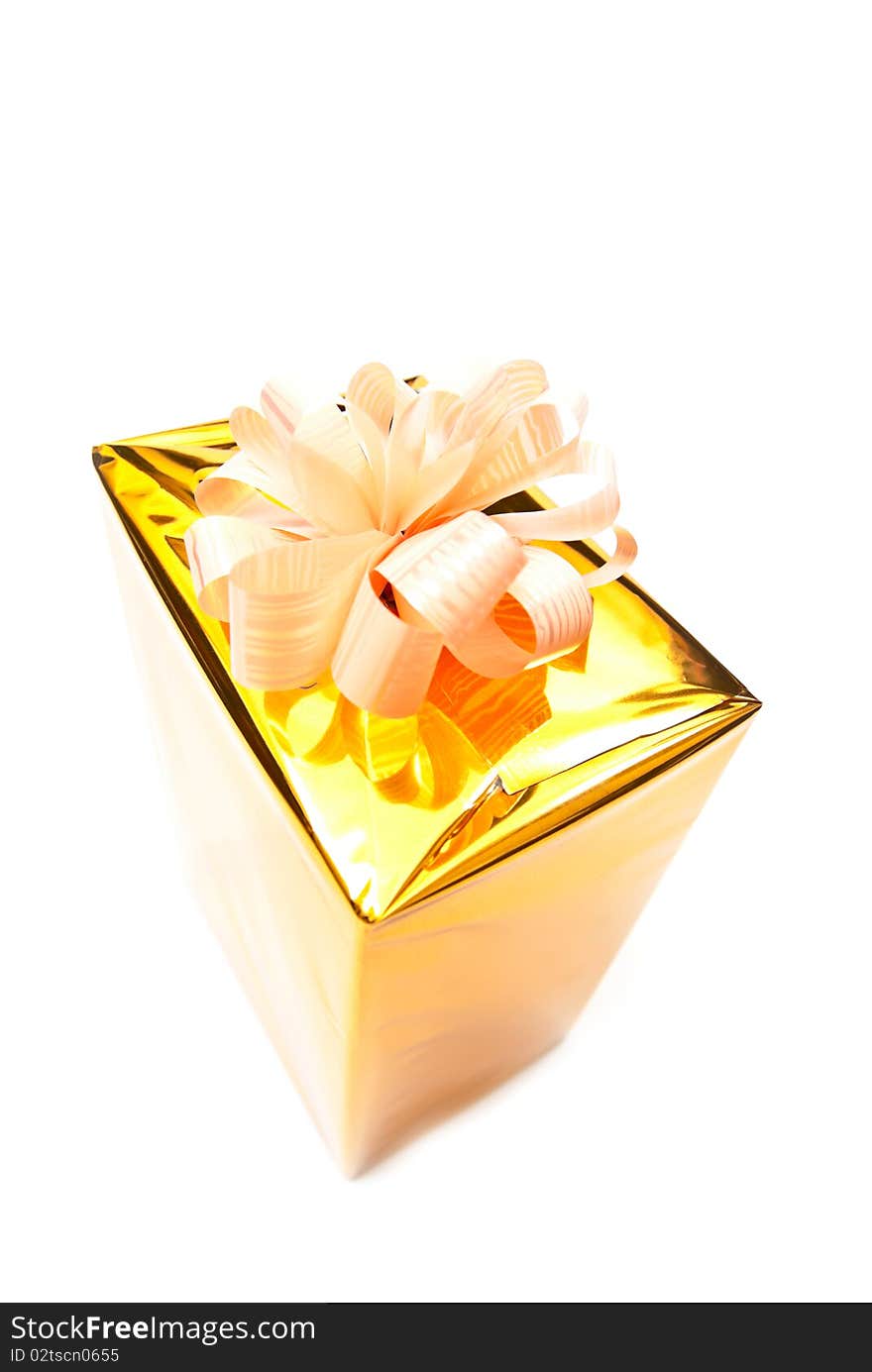 One golden gift box isolated on white. One golden gift box isolated on white