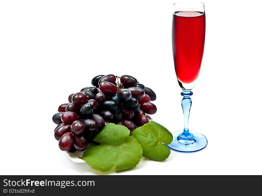 Red wine in glass with plump grapes. Isolated on white. Soft shadow. Red wine in glass with plump grapes. Isolated on white. Soft shadow