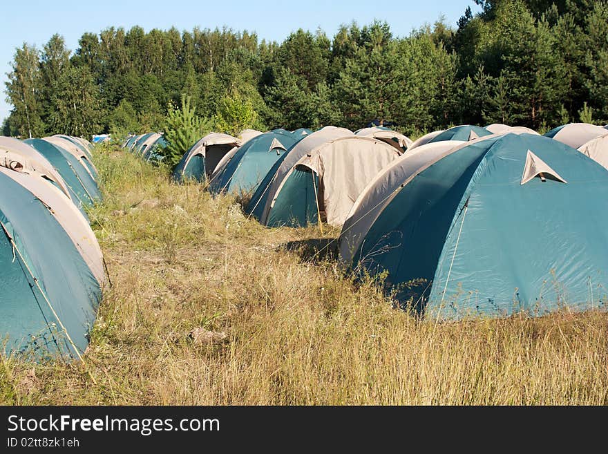 Summer day. There are many tents at forest. And nobody around. Summer day. There are many tents at forest. And nobody around.