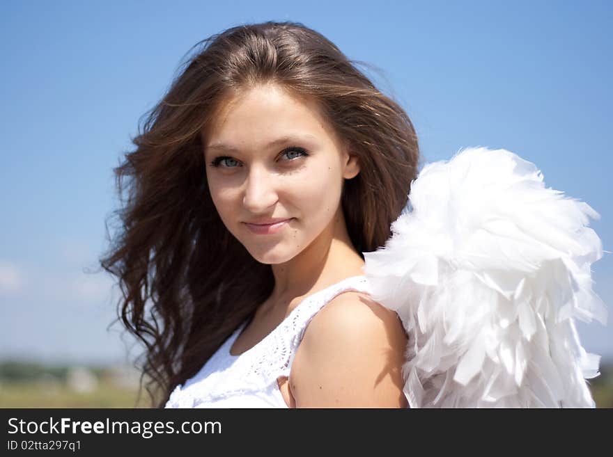 Beautiful angel girl and blue sky